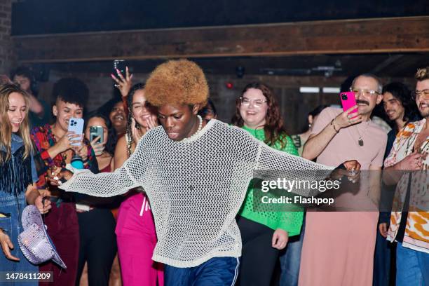 group of people dancing at a music venue. - person on phone stock pictures, royalty-free photos & images