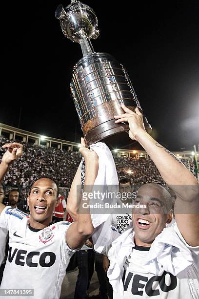 Liedson and Emerson of Corinthians, celebrate the title holding up the trophy after the second leg of the final of the Copa Libertadores 2012 between...