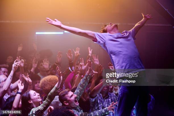 people enjoying an evening out at a music venue. - popstar stock pictures, royalty-free photos & images