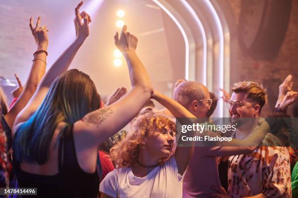 group of people dancing at a music venue. - dancing couple stock pictures, royalty-free photos & images