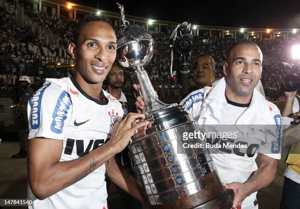 Liedson and Emerson of Corinthians, celebrate a title holding up the trophy after the second leg of the final of the Copa Libertadores 2012 between...