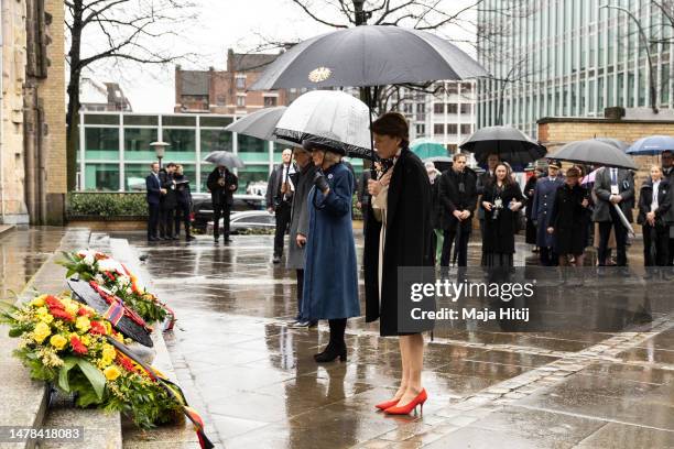 First Lady Elke Buedenbender, Camilla, Queen Consort and Eva-Maria Tschentscher place wreaths on the steps of St. Nikolai Memorial Church on March...