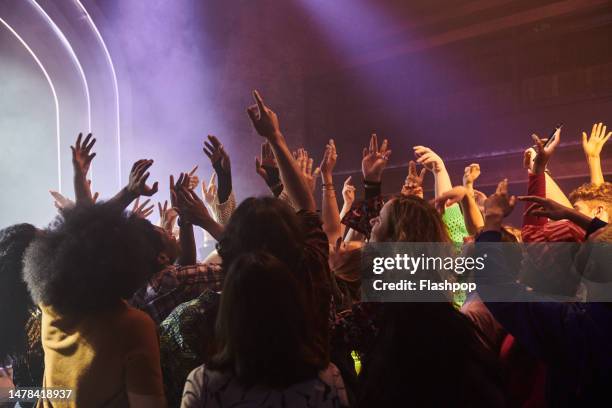 group of people dancing at a music venue. - locale notturno foto e immagini stock