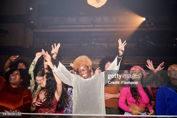 group of people dancing at a music venue. - black people partying stock pictures, royalty-free photos & images