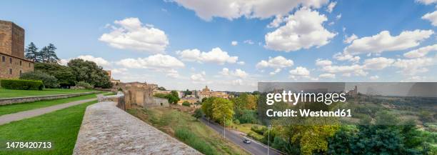 italy, lazio, tuscania, summer clouds floating over edge of town - viterbo foto e immagini stock