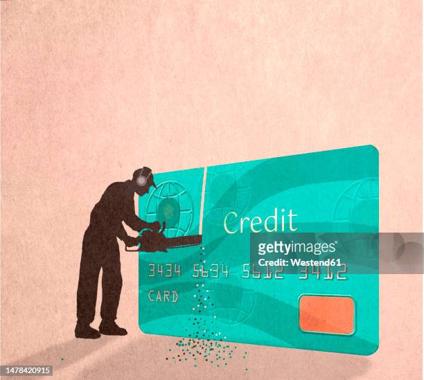 silhouette of man cutting credit card with chainsaw - cutting stock illustrations