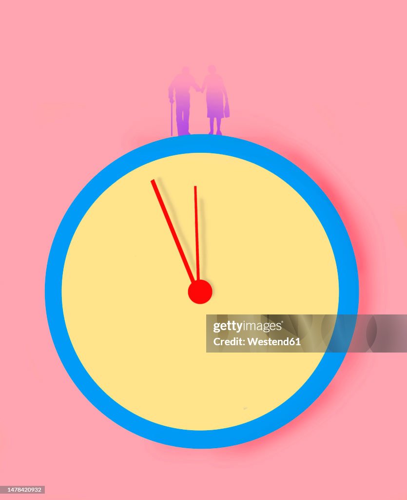Senior couple on clock against pink background