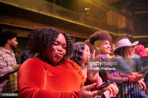 spectator pouting and showing the peace sign at a music event. - medium group of people stock pictures, royalty-free photos & images