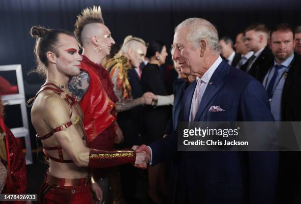 King Charles III greets Glam Rockers Lord of the Lost at Schuppen 52 on March 31, 2023 in Hamburg, Germany. The King and The Queen Consort's first...
