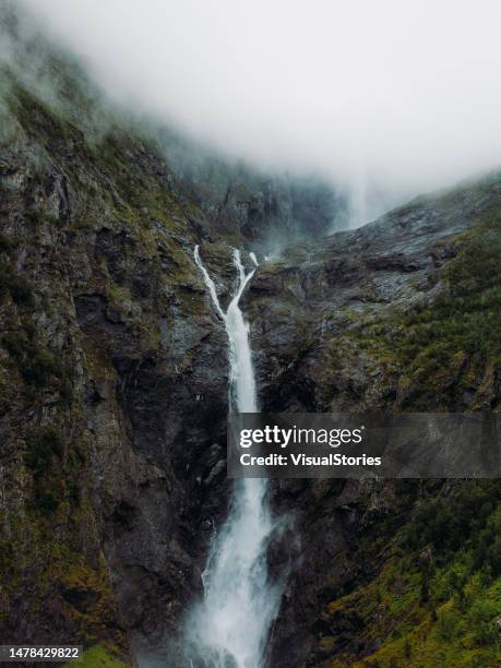 aerial views of mardalsfossen waterfall in scenic green mountain vealley in norway - green mountain aerial stock pictures, royalty-free photos & images