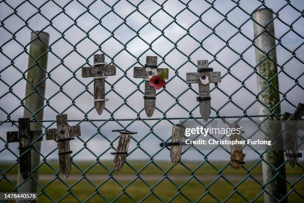 Crosses in remembrance of Dambusters aircrew are fixed to the fence of RAF Scampton on March 31, 2023 in Scampton, England. Minister for Immigration,...