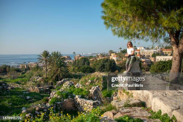 young woman traveler visiting byblos archaeological site , lebanon - byblos stock pictures, royalty-free photos & images