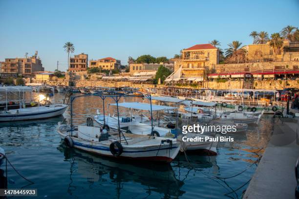 boats moored in the old peaceful mediterranean harbour of byblos, lebanon - byblos stock pictures, royalty-free photos & images