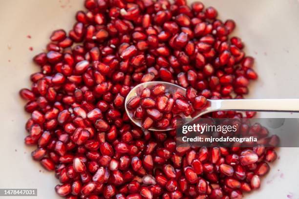 pomegranate seeds in a plate - pomegranate seed stock pictures, royalty-free photos & images