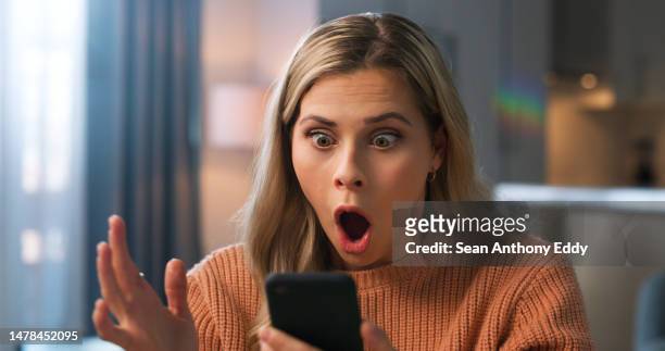 shocked woman, face or what for phone scam, phishing email or security fail in house living room. wow, anxiety or surprised person on mobile communication technology with hacker glitch or cyber theft - scandal bildbanksfoton och bilder