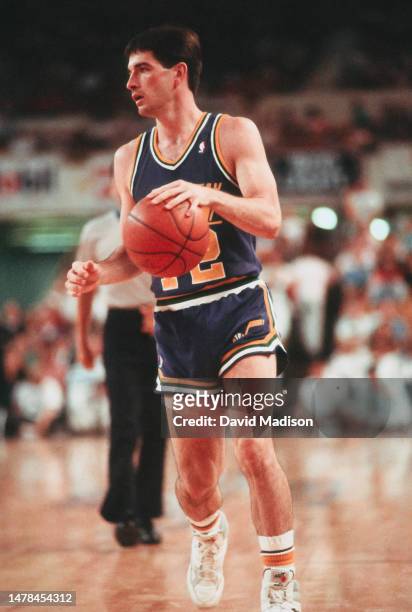 John Stockton of the Utah Jazz dribbles the ball during an NBA game against the Phoenix Suns played on April 9, 1990 at the Arizona Veterans Memorial...