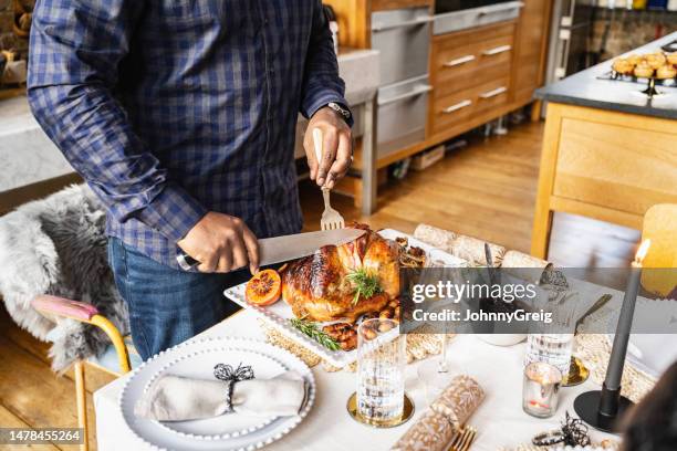 man carving roast turkey dinner - carving knife imagens e fotografias de stock