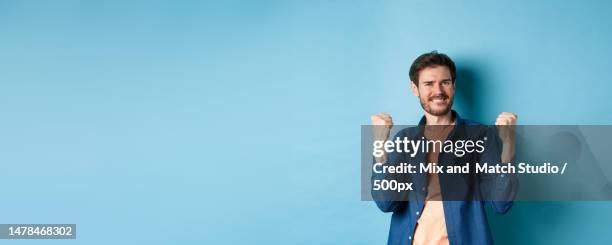 image of happy man celebrating success,shouting yes and shaking - cas awards stock pictures, royalty-free photos & images