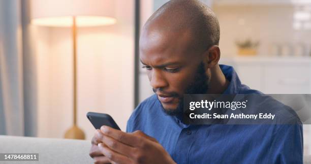 phone, black man in living room reading email or social media news on online networking website. technology, communication and internet, african person on sofa surfing web or chatting on mobile app. - notification stock pictures, royalty-free photos & images