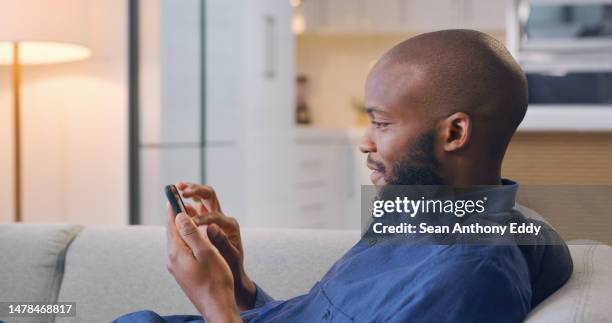 smile, phone and relax, black man on sofa reading good news email, social media meme or networking online. technology, communication and internet, happy person in home surfing website or mobile app. - meme text stock pictures, royalty-free photos & images