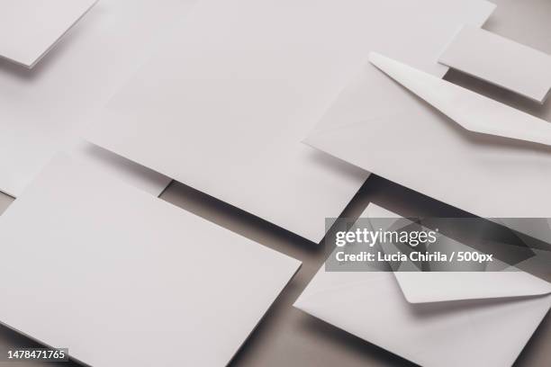 high angle view of papers on white background,romania - greeting card and envelope stock pictures, royalty-free photos & images