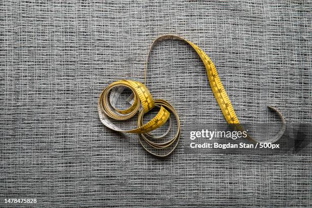 high angle view of wedding rings on table,romania - arte de la costura fotografías e imágenes de stock