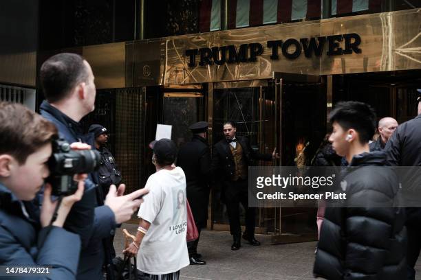 People walk by Trump Tower the morning after former president Donald Trump was indicted by a New York jury on March 31, 2023 in New York City. Trump...