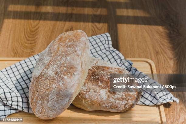 loaf of freshly homemade artisan bread on wooden board,thailand - ciabatta fotografías e imágenes de stock