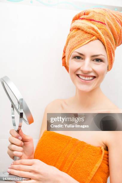 concerned woman looking at herself in mirror - bathroom closeup stock pictures, royalty-free photos & images