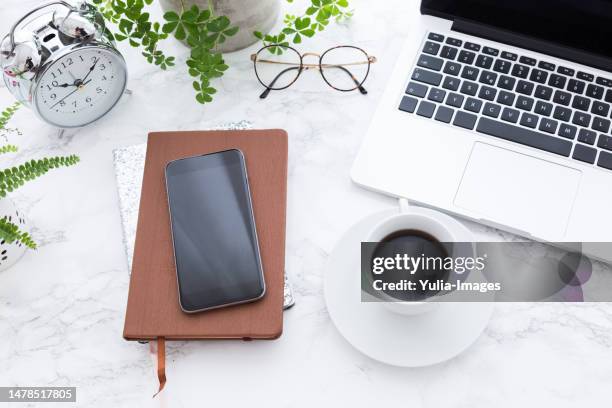 notebook smartphone laptop and coffee cup on table - office work flat lay stock pictures, royalty-free photos & images