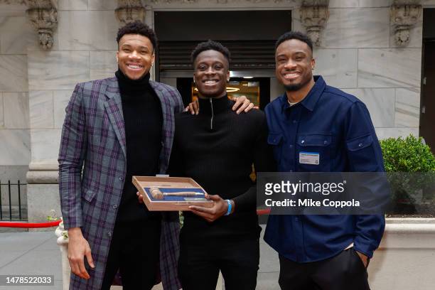 Professional basketball players Giannis Antetokounmpo, Alex Antetokounmpo, Thanasis Antetokounmpo pose for a photo before ringing the closing bell at...