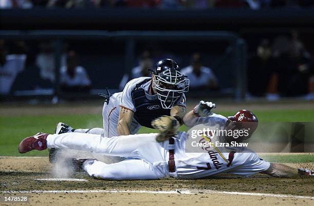 Drew of the St. Louis Cardinals is tagged out at the plate by Benito Santiago of the San Francisco Giants on October 10, 2002 during Game 2 of the...