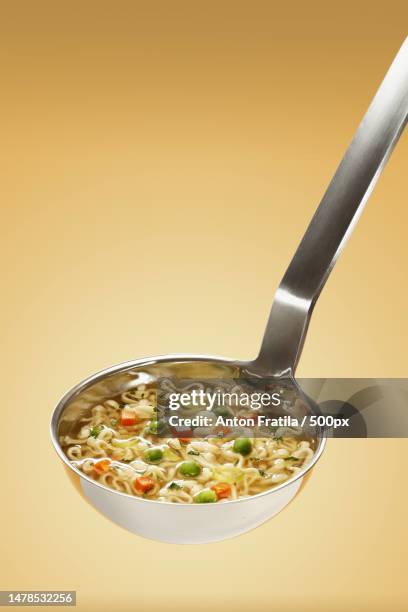 close-up of food in bowl against yellow background,romania - opscheplepel stockfoto's en -beelden