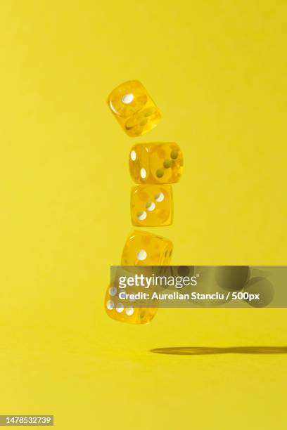 falling yellow dices on yellow background,romania - face card stockfoto's en -beelden