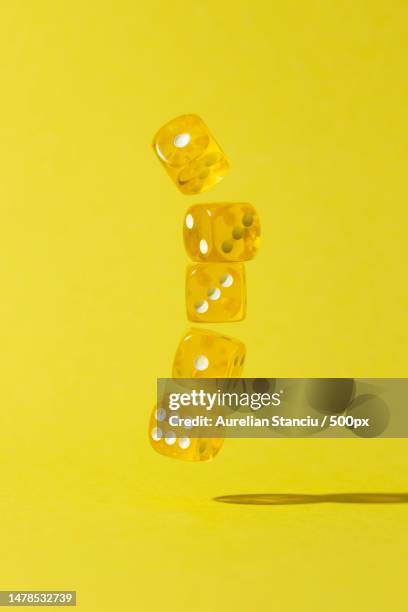 falling yellow dices on yellow background,romania - chess pieces stock pictures, royalty-free photos & images