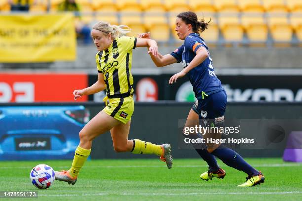 Paige Satchell of the Phoenix attempts to evade Kayla Morrison of Melbourne Victory during the round 20 A-League Women's match between Wellington...