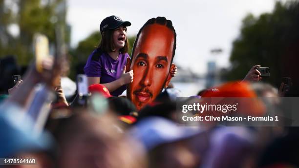 Lewis Hamilton of Great Britain and Mercedes fan shows their support on the Melbourne Walk prior to final practice ahead of the F1 Grand Prix of...