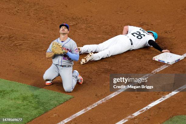 Pete Alonso of the New York Mets reacts after failing to tag out Garrett Cooper of the Miami Marlins during the third inning at loanDepot park on...