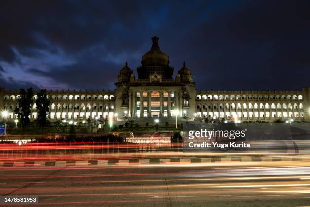 vidhana soudha (legislative house) in bangalore, karnataka, india in an evening with light trails of the traffic - indian politics and governance stock pictures, royalty-free photos & images