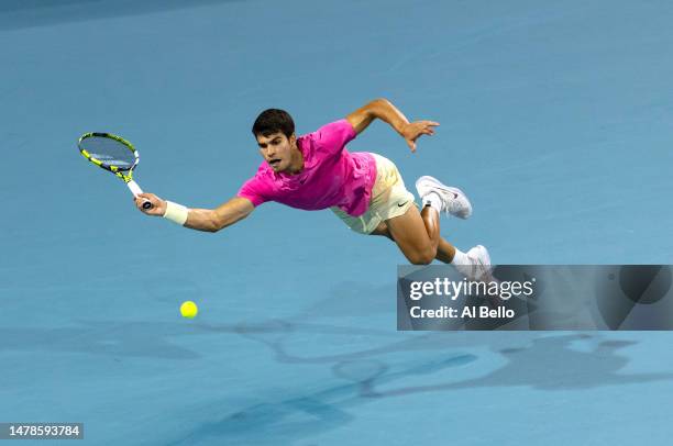 Carlos Alcaraz of Spain dives for the ball against Jannik Sinner of Italy during the semifinals of the Miami Open at Hard Rock Stadium on March 31,...