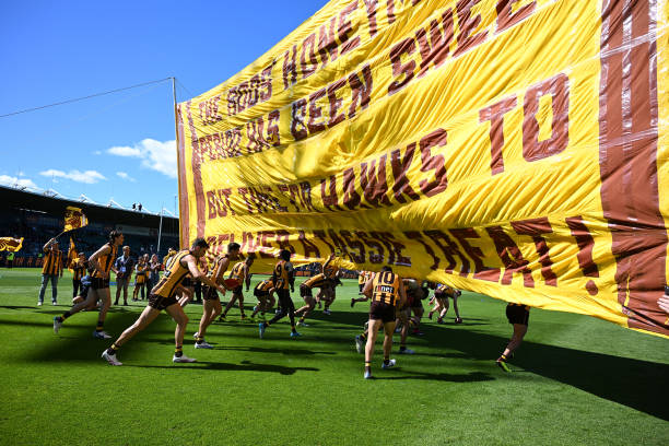 Hawks players take the field during the round three AFL match between Hawthorn Hawks and North Melbourne Kangaroos at University of Tasmania Stadium,...
