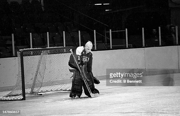 Goalie Ron Low of the Washington Capitals makes the save during warm-ups before the game against the New York Rangers on October 9, 1974 at the...