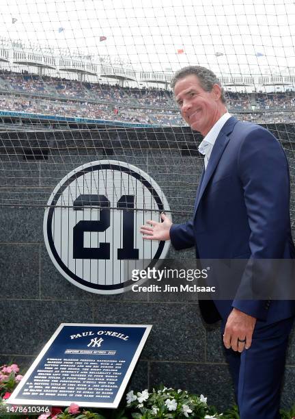 Former New York Yankee Paul O'Neill poses for a photograph with his unveiled number before a game between the Yankees and the Toronto Blue Jays at...