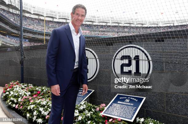 Former New York Yankee Paul O'Neill poses for a photograph with his unveiled number before a game between the Yankees and the Toronto Blue Jays at...