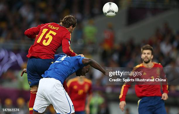 Mario Balotelli of Italy and Sergio Ramos of Spain battle for the ball during the UEFA EURO 2012 final match between Spain and Italy at Olympic...