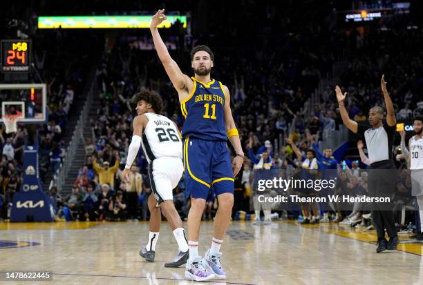 Klay Thompson of the Golden State Warriors reacts after making a three-point shot against the San Antonio Spurs during the fourth quarter at Chase...