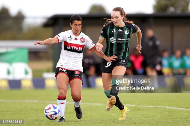 Hannah Keane of Western United kicks the ball under pressure from Malia Steinmetz of the Wanderers during the round 20 A-League Women's match between...