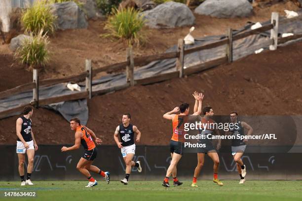 Josh Kelly of the Giants celebrates kicking a goal with team mates during the round three AFL match between Greater Western Sydney Giants and Carlton...