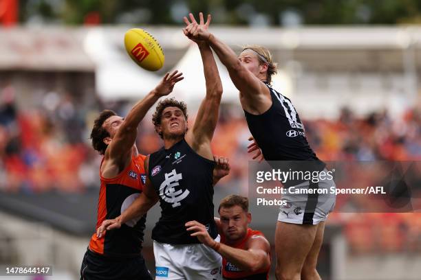 Ed Curnow of the Blues and Tom De Koning of the Blues spoil the ball during the round three AFL match between Greater Western Sydney Giants and...