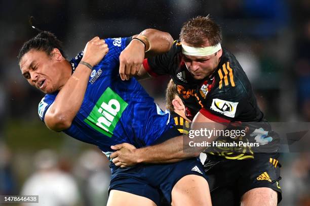 Caleb Clarke of the Blues is tackled by Sam Cane of the Chiefs during the round six Super Rugby Pacific match between Chiefs and Blues at FMG Stadium...